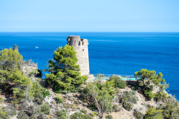 Fototapeta na wymiar Mediterranean coastal landscape. Historic Torre Vigia De Cerro Gordo, a watchtower looking out for any marauding pirates. La Herradura, Andulasia, Southern Spain