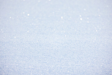 Shiny snowdrift surface on a sunny winter day, natural background