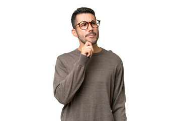 Young handsome caucasian man over isolated background having doubts and thinking