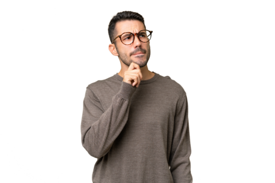 Young handsome caucasian man over isolated background having doubts and thinking