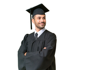 Young university graduate man over isolated background with arms crossed and happy