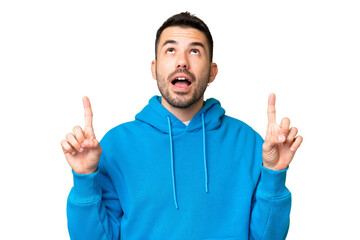 Fototapeta premium Young handsome caucasian man over isolated chroma key background surprised and pointing up