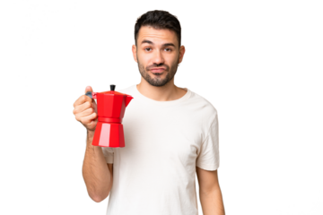 Young caucasian man holding coffee pot over isolated chroma key background with sad expression