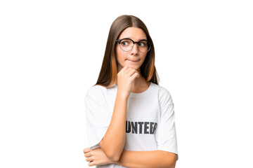Teenager volunteer caucasian girl over isolated background having doubts and thinking