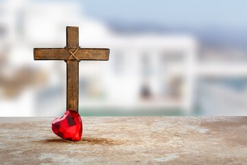 Red heart and Christian wooden cross