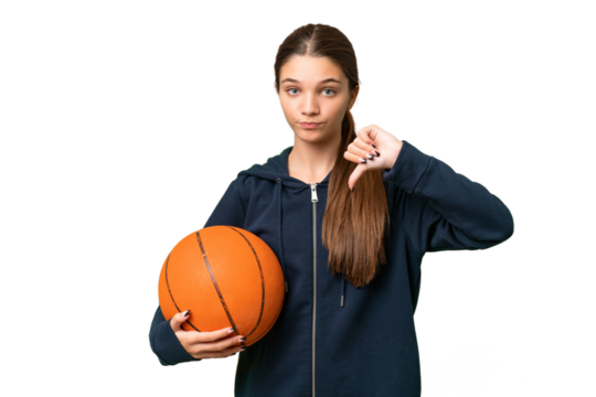 Teenager caucasian girl playing basketball over isolated background showing thumb down with negative expression