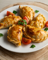 Baking delicious Argentine empanadas with chicken and vegetables.