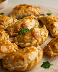 Baking delicious Argentine empanadas with chicken and vegetables.