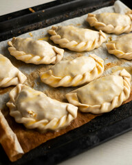 Baking delicious Argentine empanadas with chicken and vegetables.