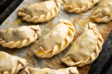 Baking delicious Argentine empanadas with chicken and vegetables.