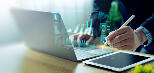 Businessman using laptop and analyzing economic growth, financial graph and business investment....