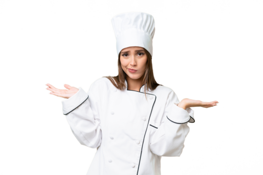 Young chef caucasian woman over isolated background having doubts while raising hands