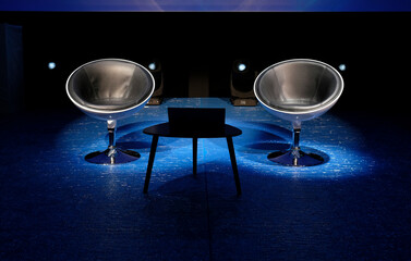 Debate or discussion - two empty chairs on stage with spotlights