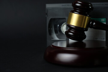 Video copyright law concept. VHS cassette tape and judge gavel