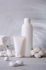 Plastic cosmeticâ€™s bottle and tube of cream and shampoo