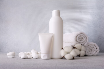 Fototapeta na wymiar Plastic cosmeticâ€™s bottle and tube of cream and shampoo