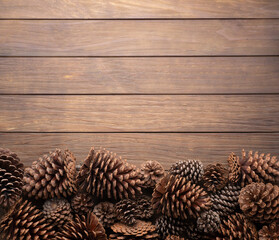 Group of pinecones over wooden table with copy space