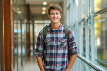 Gordijnen Smiling male student poses in high school campus. © darshika