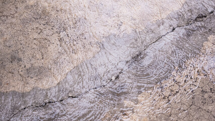 Water beneath the floor surged up through cracks of damaged concrete floor, directly above view
