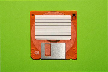Blank paper on floppy disk in green studio