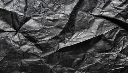 Black crumbled paper texture background.