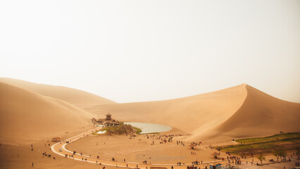 Crescent Moon Spring in Mingsha Mountain, Dunhuang City, Gansu Province - Desert scenery under a...
