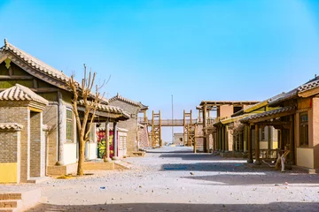 Zelfklevend Fotobehang Dunhuang Silk Road Heritage City, Dunhuang City, Gansu Province - Buildings and sand dunes in the desert © 江乐 陈