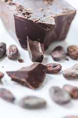 Cocoa beans with chocolate on a white background. Shalllow dof.