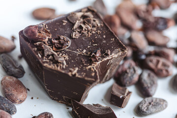 Cocoa beans with chocolate on a white background. Shalllow dof.