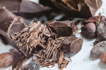 Cocoa beans with chocolate on a white background. Shalllow dof.