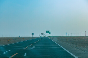 Fototapeta premium Jiuquan City, Gansu Province - Power tower, highway and Gobi scenery under the blue sky