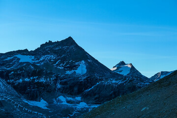 Scenic view after sunset of majestic mountain peak Hoher Sonnblick seen from Moelltaler Gletscher...