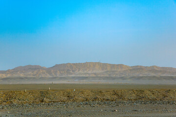 Jiuquan City, Gansu Province - Power tower, highway and Gobi scenery under the blue sky