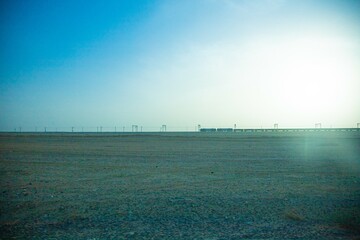 Jiuquan City, Gansu Province - Power tower, highway and Gobi scenery under the blue sky