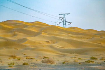 Jiuquan City, Gansu Province - Power tower, highway and Gobi scenery under the blue sky