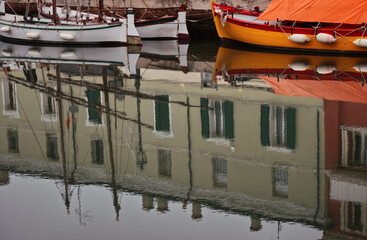 Fototapeta na wymiar Small boats reflected in the water.