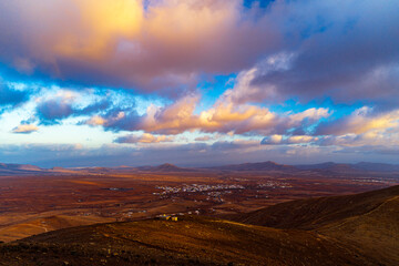 Breathtaking Landscape of a Town Amidst Vast Terrains Under a Dramatic Sky