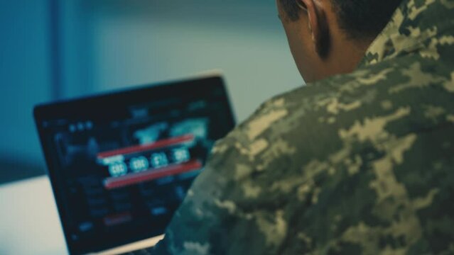 Military man looking at countdown on computer, reconnaissance satellite launch