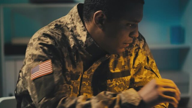 American serviceman working at military command center, planning strategy
