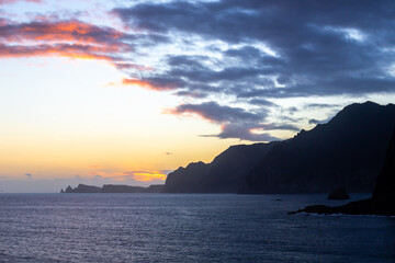 Dawn on Ilhéu da Pocariça cliffs from the distance - Madeira, Portugal 