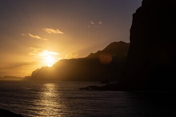 Sunrise from behind of cliffs - Guindaste viewpoint - Madeira, Portugal