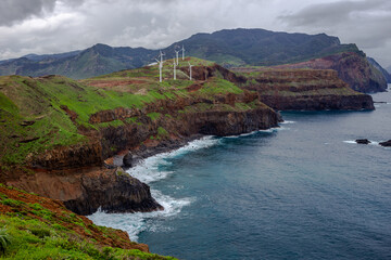 Rocky coast with wind farm from viewpoint - Ponta do Rosto - Madeira, Portugal