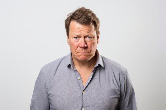 Middle age man making funny face on grey background. Negative facial expression