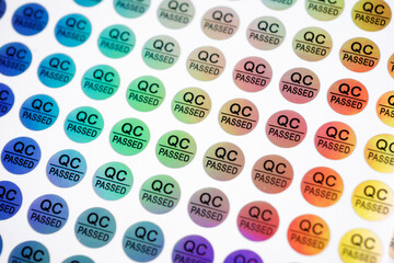 Close-up of stickers with text QC passed