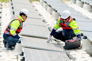 One professional technician worker sit and touch solar cell panel and discuss with co-worker for...