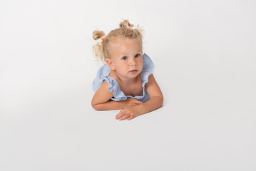 little blonde girl lying on the floor looking at camera