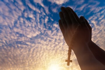Human male hand with the rosary and cross