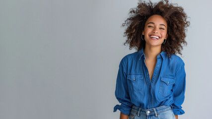 Afro woman wearing blue shirt smiling laugh out loud isolated on grey