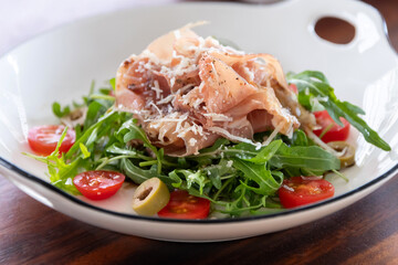 Parma ham and mozzarella with rocket, extra virgin olive oil and balsamic vinegar salad.