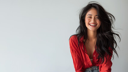 Fototapeta premium Malay woman wearing red shirt smiling laugh out loud isolated on grey